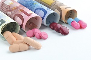 medical pills and tablets in euro bank notes money as a symbol o